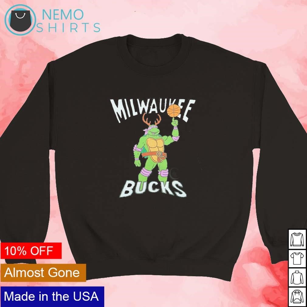 https://images.nemoshirt.com/2023/12/TMNT-Donatello-Milwaukee-Bucks-shirt-new-mockup-black-sweater.jpg